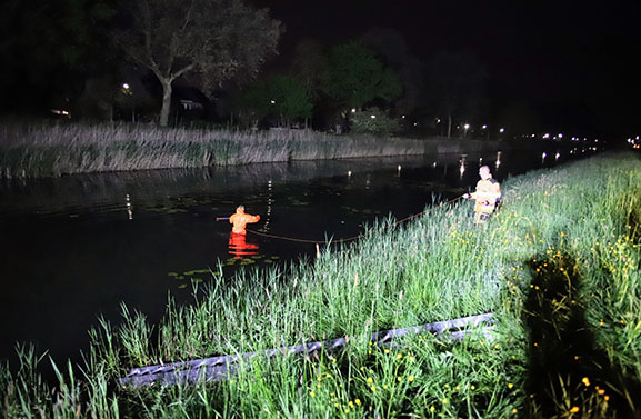 Man vast met voet onder scootmobiel in water aan de Inudatiedijk-Zuid